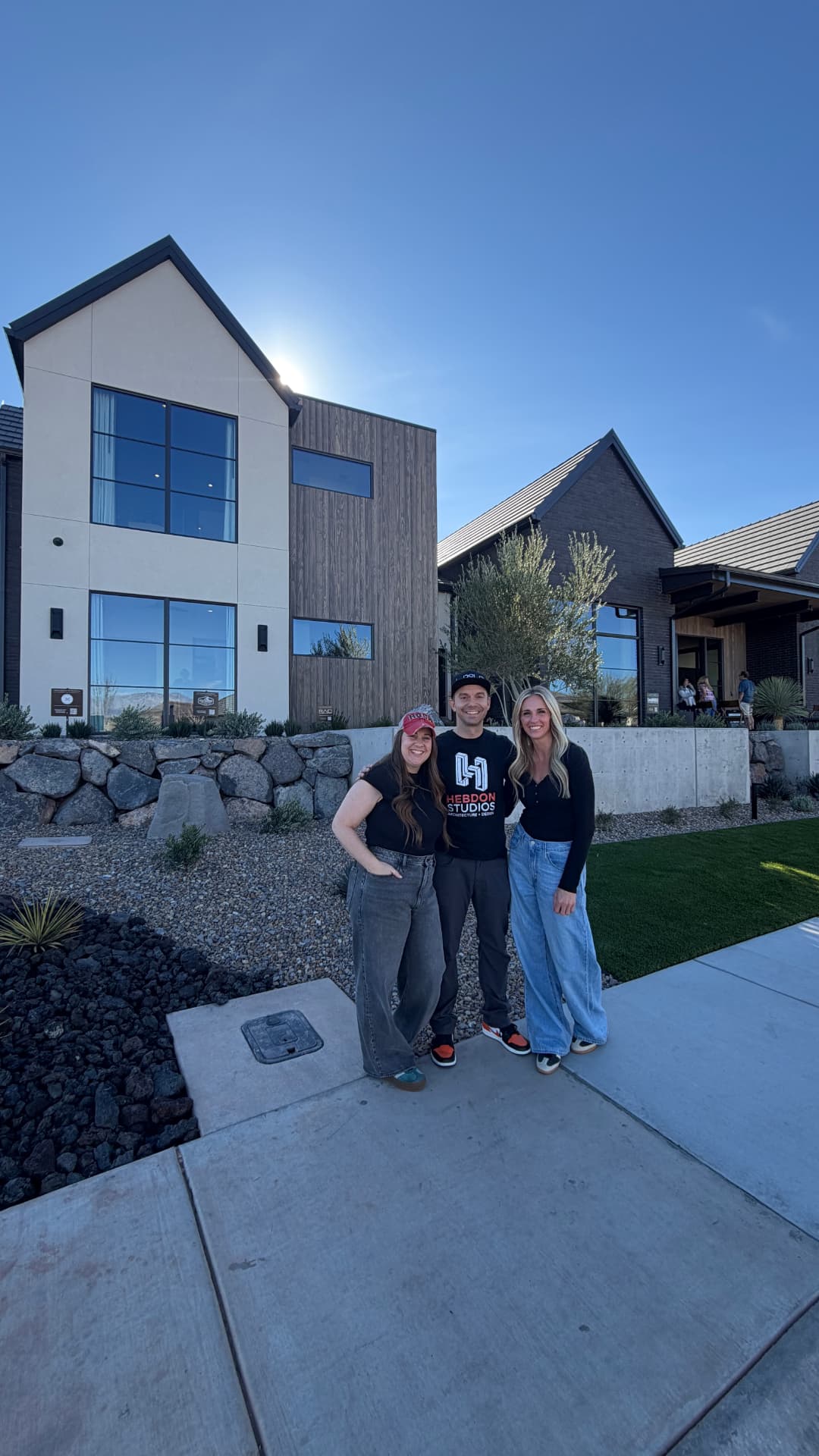Lindy with an architect and designer outside a two-story custom home