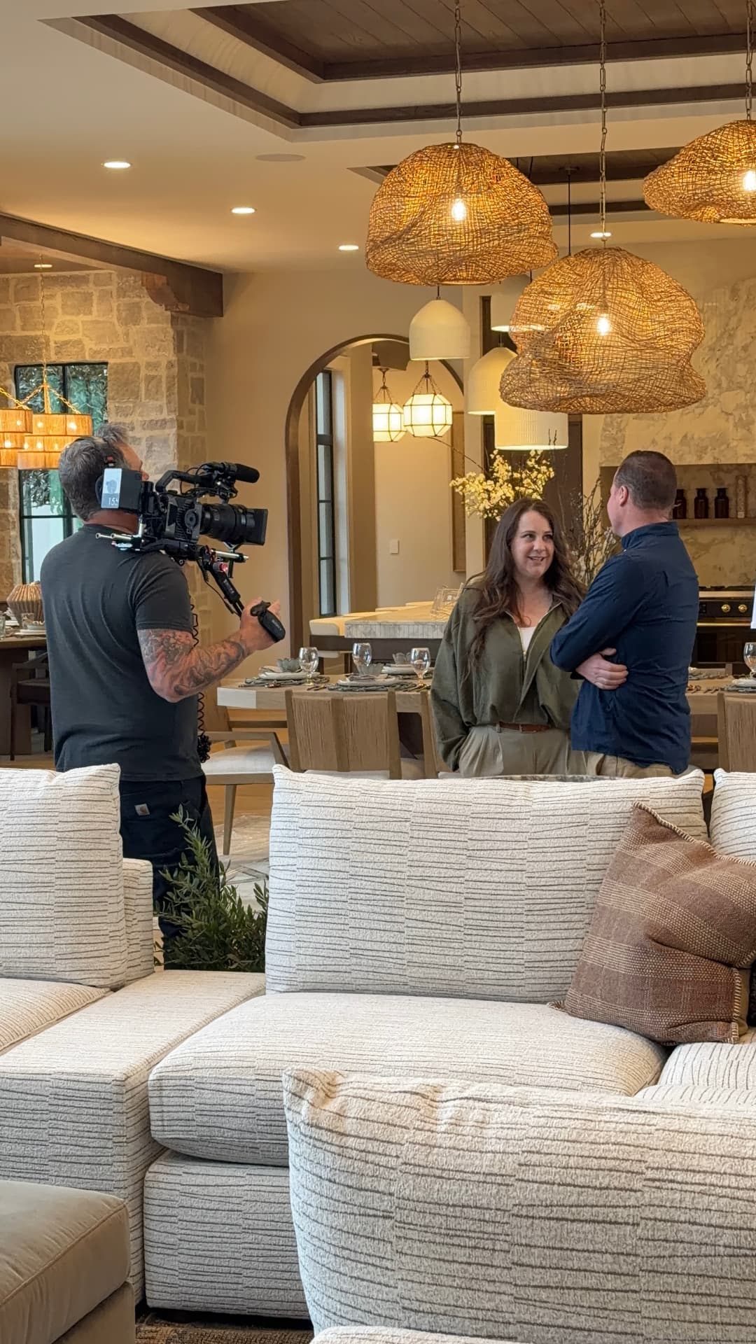 Lindy interviewing a builder on camera in a Texas-style great room